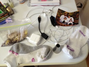 A family picture from 5 years ago, two iPhone cords, earbuds, some other random cord, a Fitbit that doesn't work, two mis-matched socks (??), a bag of crumbled up cookies, and an icing tip. Because you never know when you're going to have a cupcake decorating emergency.