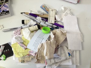 Pens, gum wrappers, grocery lists, receipts, a crumpled up napkin, and who knows what else.